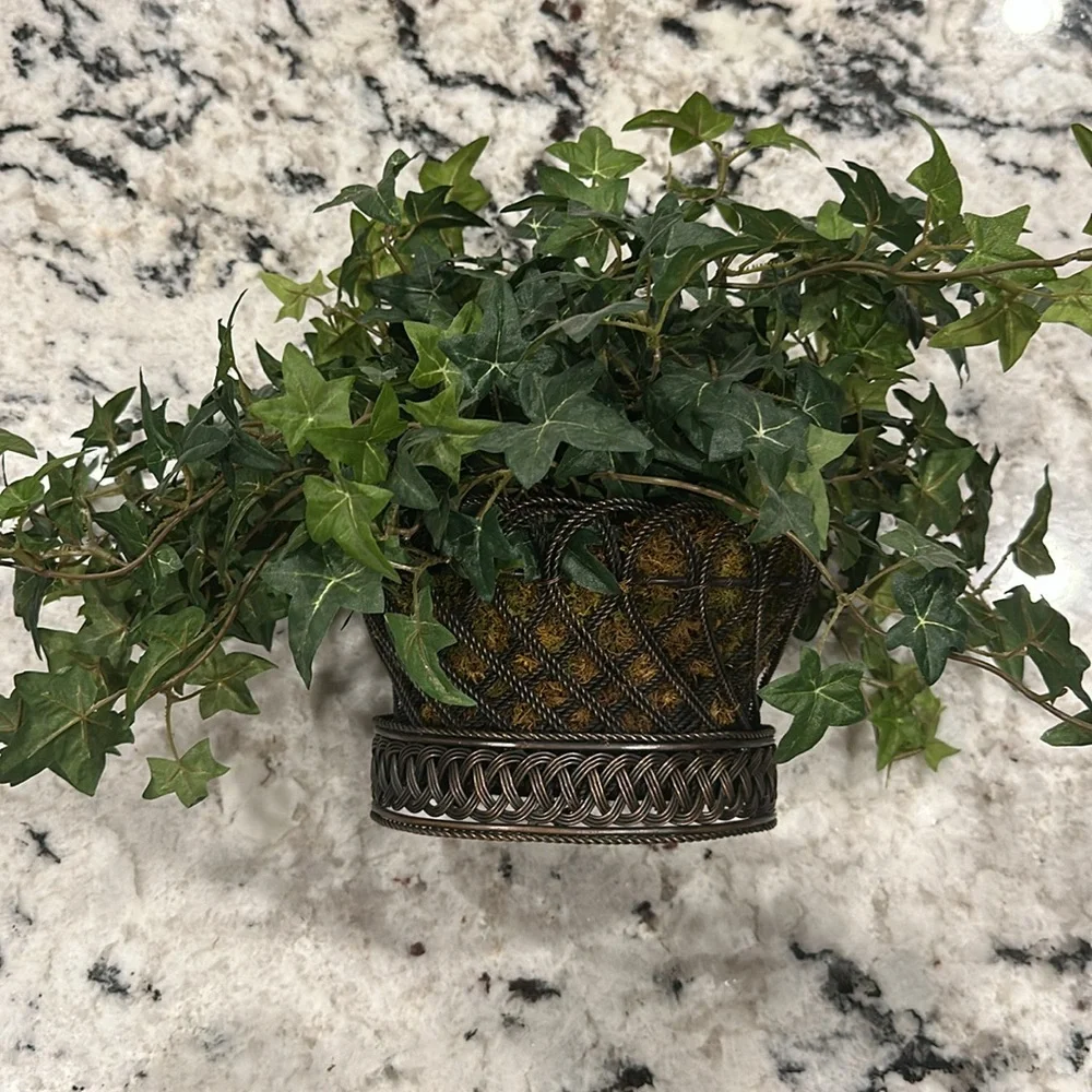 Gorgeous metal basket with realistic greenery.
